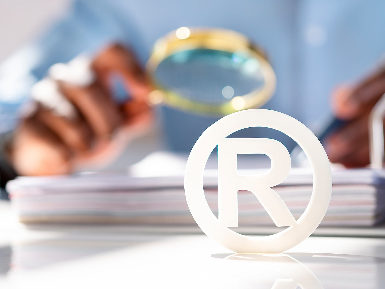 A trademark symbol on a table in front of a person