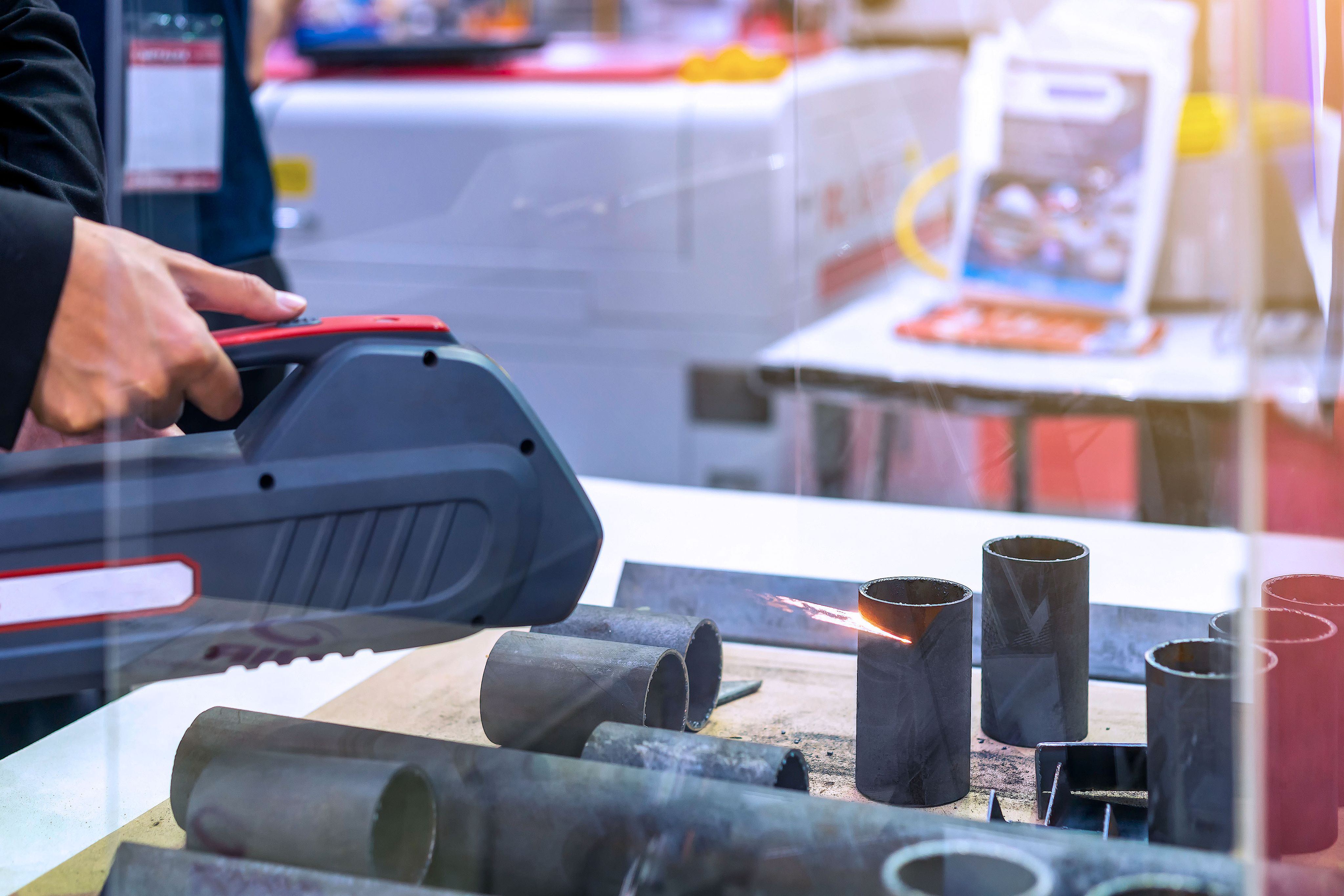 Photo of a laser cleaning device removing rust from iron pipes